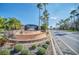 Cumbrian Lakes community entrance featuring a fountain and palm tree lined streets at 1207 Winding Cypress Ct, Kissimmee, FL 34746
