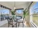 Bright dining nook with a glass table, comfortable seating, and multiple windows with scenic views at 1207 Winding Cypress Ct, Kissimmee, FL 34746