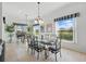 Sunlit dining room features wrought iron chairs, tile flooring, and plenty of natural light at 1207 Winding Cypress Ct, Kissimmee, FL 34746