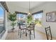 Bright dining nook with a glass table, comfortable seating, and multiple windows with scenic views at 1207 Winding Cypress Ct, Kissimmee, FL 34746