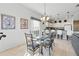 Cozy dining area featuring modern lighting fixtures, artwork, and seamless access to the kitchen at 1207 Winding Cypress Ct, Kissimmee, FL 34746