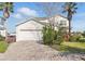 Charming home featuring a brick driveway, attached two-car garage, and well-maintained landscaping at 1207 Winding Cypress Ct, Kissimmee, FL 34746