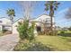 Beautiful two-story home with manicured lawn, lush landscaping, and a welcoming green front door at 1207 Winding Cypress Ct, Kissimmee, FL 34746