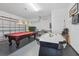 Large game room complete with a pool table and air hockey table at 1207 Winding Cypress Ct, Kissimmee, FL 34746