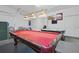 A large game room featuring a pool table with bright overhead lighting at 1207 Winding Cypress Ct, Kissimmee, FL 34746