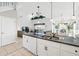 Open kitchen with an island, white cabinets, black countertops, and seamless access to the living area at 1207 Winding Cypress Ct, Kissimmee, FL 34746