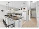 Spacious kitchen featuring white cabinetry, a black countertop island, and seating for casual dining at 1207 Winding Cypress Ct, Kissimmee, FL 34746