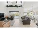 Bright living room with sofas, tile floors, and vaulted ceilings leading to dining area at 1207 Winding Cypress Ct, Kissimmee, FL 34746