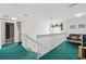 Cozy loft featuring a staircase and comfortable seating, creating a perfect retreat within the home at 1207 Winding Cypress Ct, Kissimmee, FL 34746