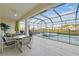 Covered lanai with a large swimming pool and spa overlooking the yard at 1207 Winding Cypress Ct, Kissimmee, FL 34746