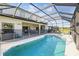 Screened-in pool with lounge chairs, hot tub, and safety fence, perfect for relaxation and safety at 1207 Winding Cypress Ct, Kissimmee, FL 34746