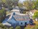 Aerial shot showcasing the house with trees, surrounding neighborhood, and parking area at 100 N Main St, Winter Garden, FL 34787