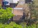 Aerial perspective of a home's roof surrounded by trees, indicating neighborhood layout at 100 N Main St, Winter Garden, FL 34787