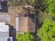 Aerial view of a home's roof surrounded by trees, showcasing its position and surroundings at 100 N Main St, Winter Garden, FL 34787