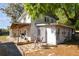 Backyard featuring a covered patio, white siding, and a door for outdoor access at 100 N Main St, Winter Garden, FL 34787
