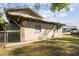 Exterior shot of backyard with a fence and a partially obscured view of a two-story house at 100 N Main St, Winter Garden, FL 34787