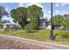 Quaint home with mature trees, a well-kept lawn, and classic street lighting at 100 N Main St, Winter Garden, FL 34787