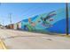 A building wall with a beautiful hummingbird and flower mural is featured in Winter Garden at 100 N Main St, Winter Garden, FL 34787
