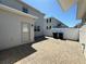 Backyard featuring a brick patio, a white fence, and the back door of the house at 10079 Memoir Ave, Winter Garden, FL 34787