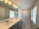 Bathroom boasts a double sink vanity with a glass enclosed shower at 10079 Memoir Ave, Winter Garden, FL 34787