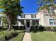 Charming two-story home with manicured lawn and welcoming front porch columns and black shutters at 10079 Memoir Ave, Winter Garden, FL 34787