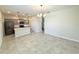 Bright, open layout with tile flooring connecting the kitchen, dining area and the island at 10079 Memoir Ave, Winter Garden, FL 34787