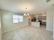 Open floor plan featuring a stylish kitchen island, sleek appliances, and tile flooring at 10079 Memoir Ave, Winter Garden, FL 34787