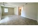 The living room boasts tile flooring, light walls, and a view to the staircase at 10079 Memoir Ave, Winter Garden, FL 34787