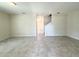 Spacious open-concept living room with neutral walls and tile flooring leading to the stairwell at 10079 Memoir Ave, Winter Garden, FL 34787
