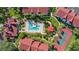 Aerial view showcasing the community pool, tennis courts, lush landscaping, and well-maintained buildings at 11568 Westwood Blvd # 1021, Orlando, FL 32821