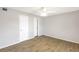 An empty bedroom with wood-look floors, a ceiling fan, and two closets at 11568 Westwood Blvd # 1021, Orlando, FL 32821