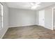 An empty bedroom with wood-look floors, a ceiling fan, and a window at 11568 Westwood Blvd # 1021, Orlando, FL 32821