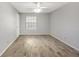 An empty bedroom with wood-look floors, a ceiling fan, and a window at 11568 Westwood Blvd # 1021, Orlando, FL 32821
