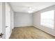 An empty bedroom with wood-look floors, a ceiling fan, and a window at 11568 Westwood Blvd # 1021, Orlando, FL 32821