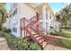 Condo's charming exterior featuring stairs and well-manicured landscaping at 11568 Westwood Blvd # 1021, Orlando, FL 32821
