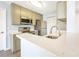 Bright kitchen with updated appliances, quartz countertops, and neutral cabinetry at 11568 Westwood Blvd # 1021, Orlando, FL 32821