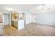 Open layout with living and kitchen areas featuring modern flooring and ample natural light at 11568 Westwood Blvd # 1021, Orlando, FL 32821