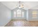 Spacious living room featuring vaulted ceilings, a ceiling fan, and wood-look floors at 11568 Westwood Blvd # 1021, Orlando, FL 32821