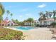 Beautiful community pool surrounded by mature palm trees at 11568 Westwood Blvd # 1021, Orlando, FL 32821