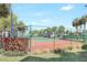 Community tennis court surrounded by lush greenery, perfect for a friendly match at 11568 Westwood Blvd # 1021, Orlando, FL 32821