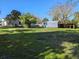 The yard features a versatile storage shed and a shaded wooden structure, enhancing functionality at 11847 Ocklawaha Dr, Leesburg, FL 34788