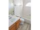 Bathroom features a tub and shower combination, tile surround, updated vanity, and bright natural light at 11847 Ocklawaha Dr, Leesburg, FL 34788