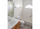 Bathroom features a tub and shower combination, tile surround, updated vanity, and bright natural light at 11847 Ocklawaha Dr, Leesburg, FL 34788