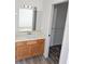 Bright bathroom features a mirror, vanity, and walk-in closet at 11847 Ocklawaha Dr, Leesburg, FL 34788