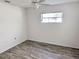 This bedroom features new flooring, light colored walls and ceilings, and sunny window at 11847 Ocklawaha Dr, Leesburg, FL 34788