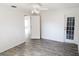 Bright bedroom featuring wood flooring and access to ensuite and outdoor patio at 11847 Ocklawaha Dr, Leesburg, FL 34788
