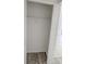 Empty closet with a wood floor and a metal hanging rod at 11847 Ocklawaha Dr, Leesburg, FL 34788
