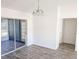 Open dining area with sliding glass doors and updated laminate flooring at 11847 Ocklawaha Dr, Leesburg, FL 34788