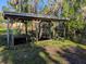 Back yard dock featuring a covered platform, offering a serene waterfront experience at 11847 Ocklawaha Dr, Leesburg, FL 34788