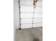 Garage door featuring a multi-panel design and secure hardware at 11847 Ocklawaha Dr, Leesburg, FL 34788